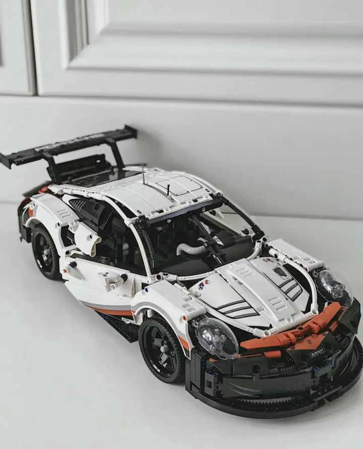 A highly detailed 2003-piece Porsche 911 Building Blocks Technology Super Sports Car Model featuring sleek aerodynamic lines, realistic cockpit, and engine bay, perfect for car enthusiasts and collectors.